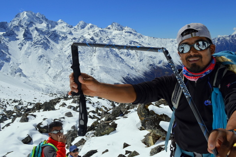 A Sherpa displays a broken trekking pole in the snowy mountains of Langtang