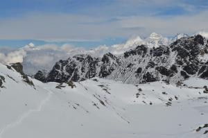 A snowy scene with the faraway peaks of the 8000 meter Manaslu on the left, and the Ganesh Himal to the right