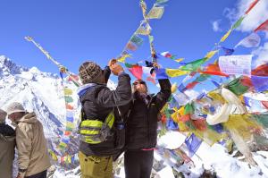 Hanging prayer flags on the summit