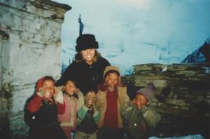 Mary Ellen with the kids of Ghyaru and a wall of Annapurna ice in the background